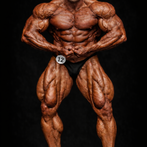 2007 Aristos Aristeridou professional bodybuilder performing a front pose on stage, showcasing extreme muscle mass, definition, and conditioning