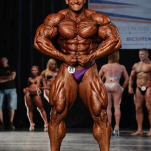 Aristos Aristeidou IFBB Cyprus bodybuilding champion posing on stage